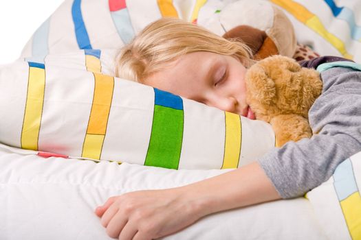 Sleeping young cute child in a colorful bed