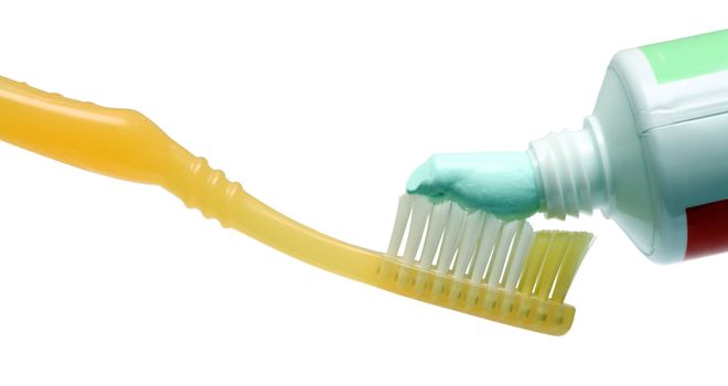 toothbrush with toothpaste isolated on white