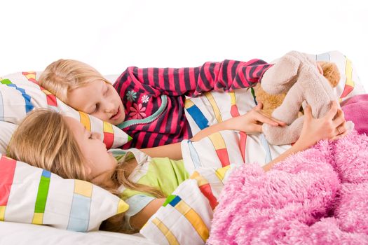 Two young children enjoying their colorful bed