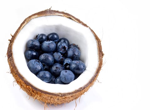 healthy fresh fruits - blueberries and coconut isolated on white background