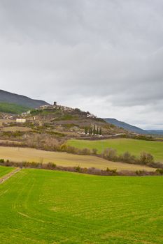 Medieval Spanish Town Surrounded by Fields and Mountains in the Rainy Weather