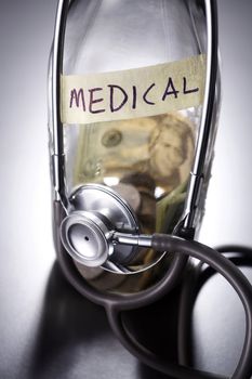A bottle of cash with a stethoscope.