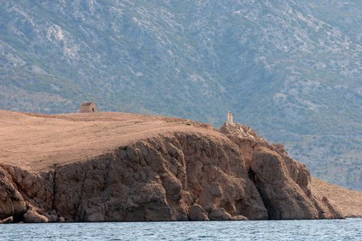 A hilltop house and lighthouse above the Adriatic sea near the town of Pag.