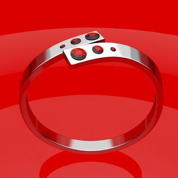 Silver ruby ring on shiny red background