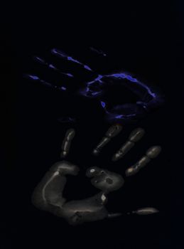 Blue and gray hand-print shape over black background