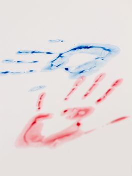 Blue and red hand-print shape over white background