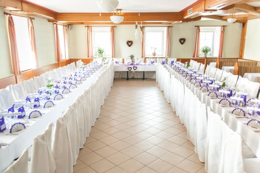 Decorated tables on a wedding celebration in a festive hall