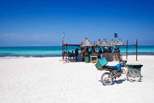 People eating and drinking in a beach bar.