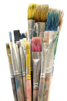 Bunch of dirty paintbrushes. Isolated on a white background.