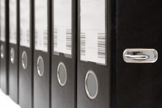 Row of black ring binders.