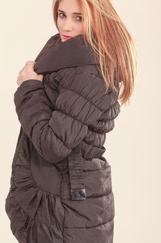 Attractive girl in a warm quilted coat