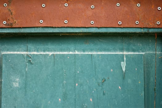 Wooden chipped paint blue door detail. Weathered wood background texture.