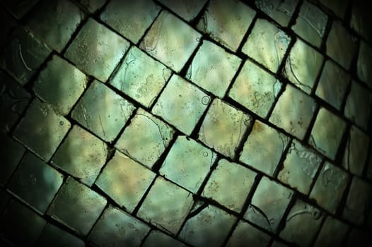 Stained broken glass squares texture macro. Abstract background selective focus.