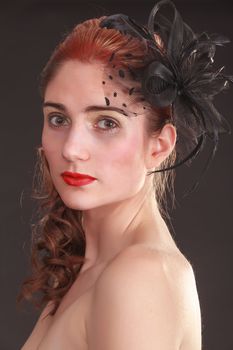 Portrait of a model with an elaborate hairstyle and bow in her hair
