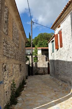 Narrow street and traditional houses in village Louha in the island of Zakynthos, Greece.