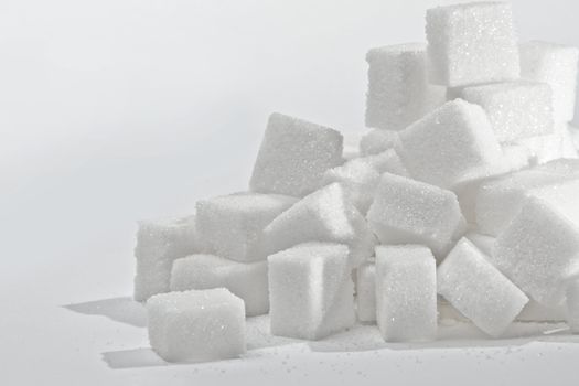 Close up on the stack of white sugar cubes.