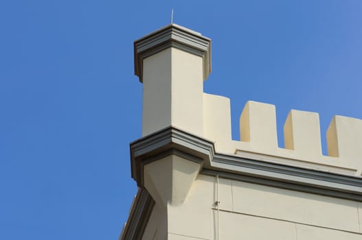 19th century building with decorative tower battlements. Architectural detail.