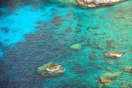 Crystal clear blue sea water at rocky beach in Zakynthos, Greece.