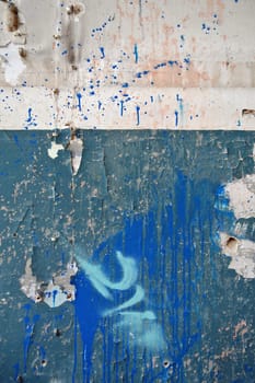 Weathered peeling wall surface with messy splashed paint. Abstract background.