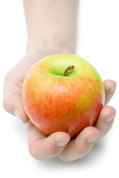 Female hand offering a colorful apple. Isolated on a white background.