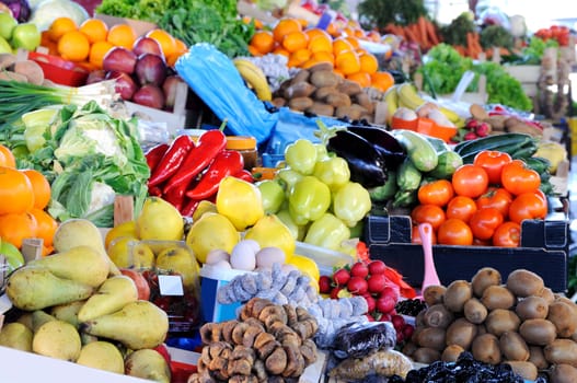 Market place with loot of tips of vegetables and fruits