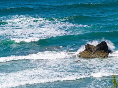 Boulder on the Shore with Waves Crashing