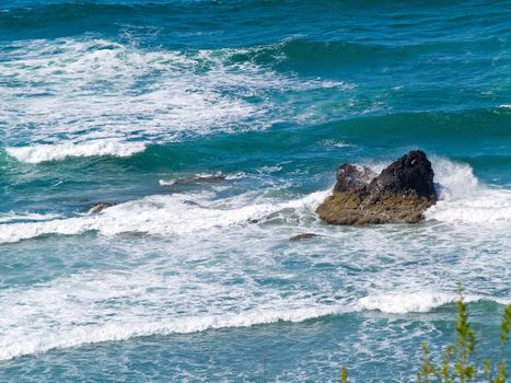 Boulder on the Shore with Waves Crashing