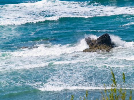 Boulder on the Shore with Waves Crashing