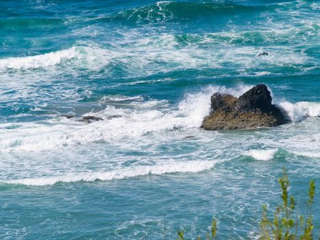 Boulder on the Shore with Waves Crashing