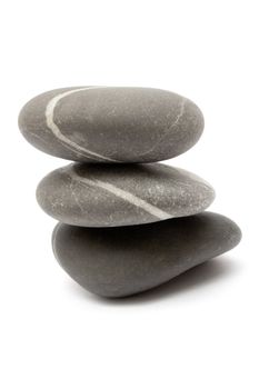 Three gray stones stacked on each other. Isolated on a white background.