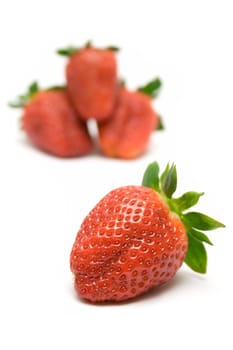 Bunch of Strawberries. Front one focused. Isolated on a white background.