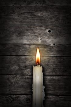 candle in front of old wooden planks