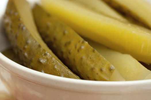 Closeup view of sliced pickled cucmbers in a bowl