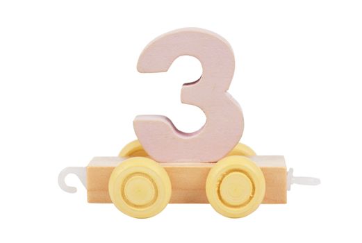 Wooden toy on a wheels number 3 isolated over white