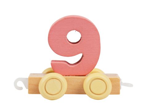 Wooden toy on a wheels number 9 isolated over white
