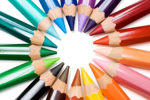 Colored pencils forming a color circle. White background.