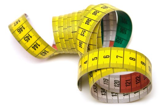 Winding tape measure against white.