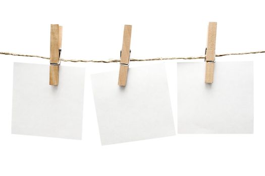 Three notes hanging on a clothesline. Isolated on a white background.