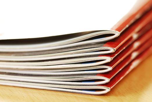 stack of same magazines with red covers closeup