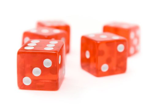 Translucent red dice isolated on a white background. Shallow depth of field.