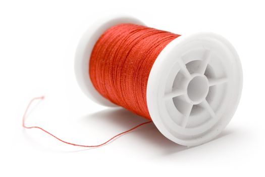 Spool of red thread isolated on white.