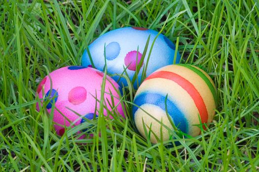 Colorful eggs hidden in green grass.