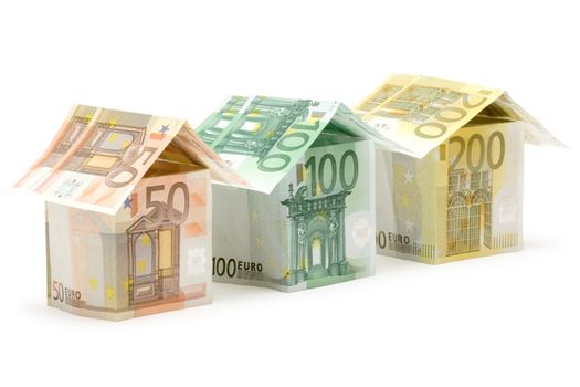 Three colorful houses built of different euro bills. Isolated on a
white background.