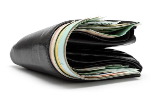 Black purse full of banknotes isolated on a white background.