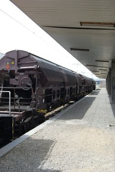 Freight wagons on railway station in perspective