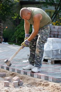 Worker on job. Constructing a new street