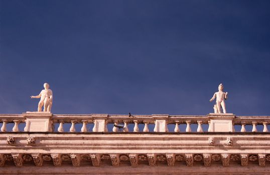 Marble statues frame on blue sky background
