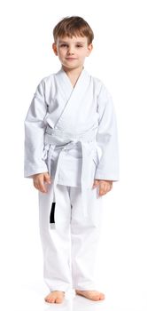 Aikido boy fighting position in white kimono isolated on white