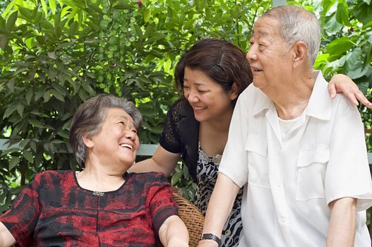 a happy senior couple and their daughter  