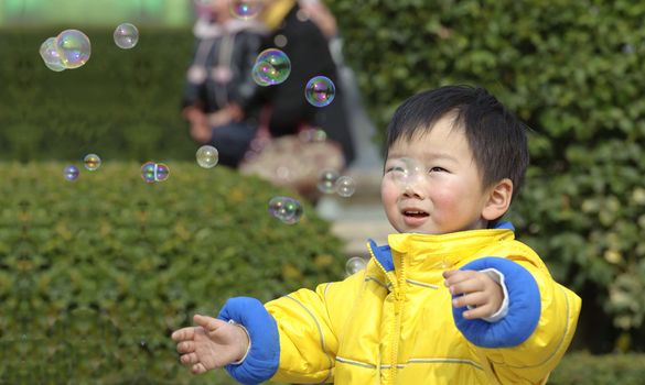baby playing soap bubbles